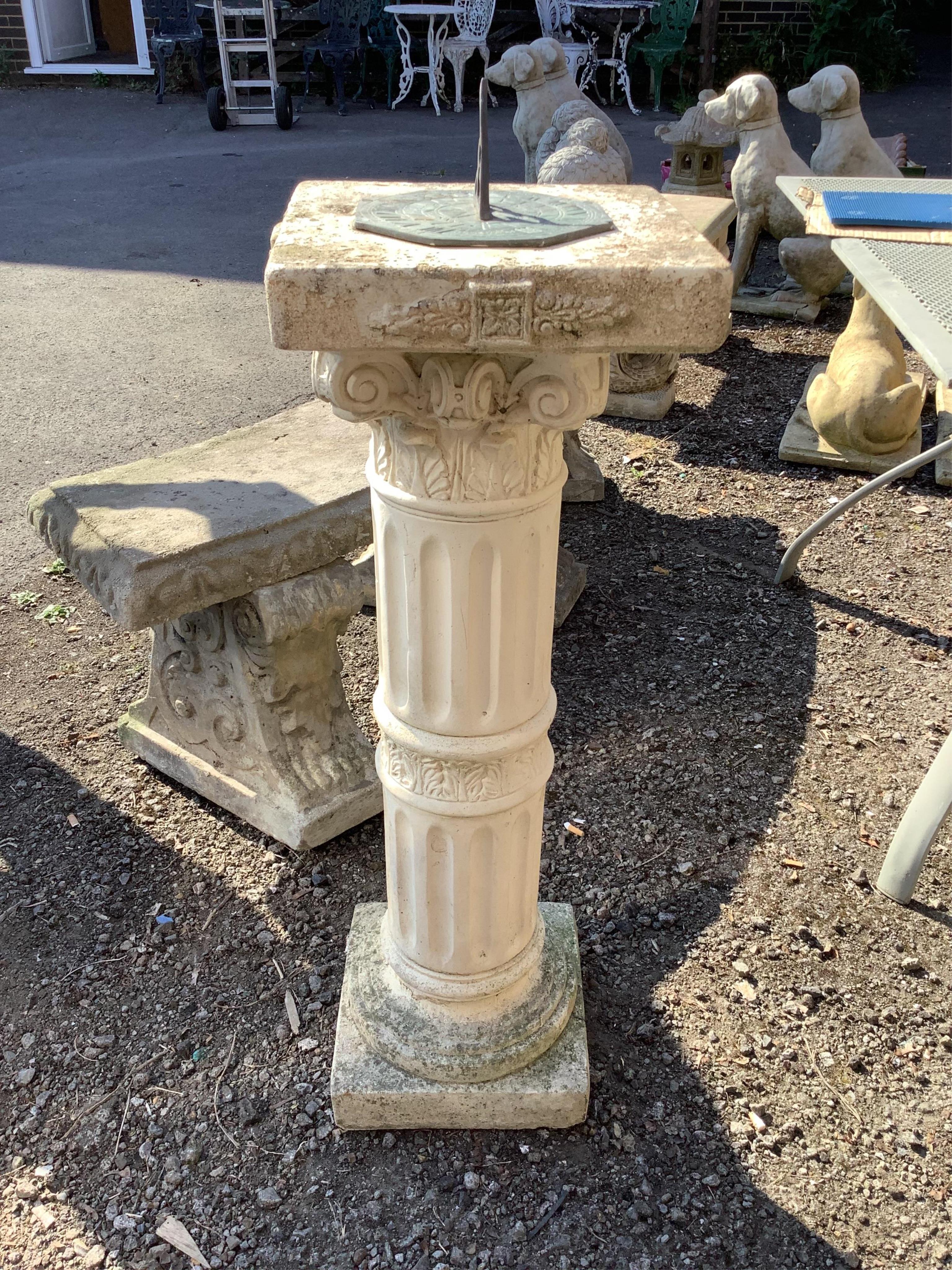 A reconstituted stone sundial with fluted pillar, height 98cm. Condition - good